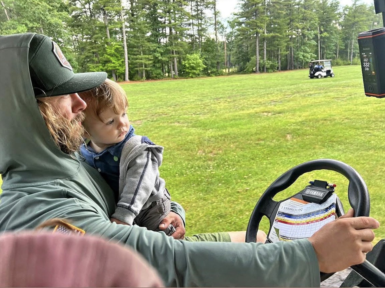 Todd and his son on the golf course